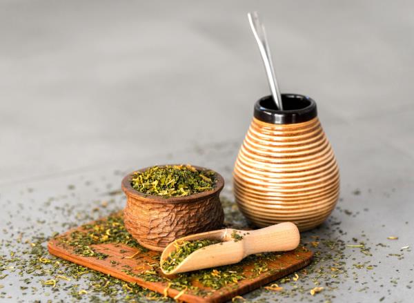 yerba mate in gourd and leaves, co<em></em>ncept of yerba mate for weight loss