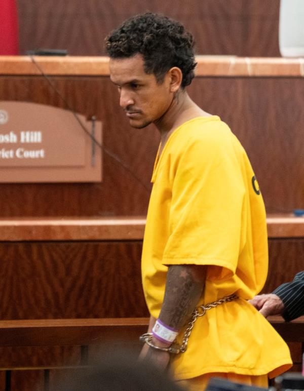Franklin Jose Pena Ramos, 26, appears in court in a yellow jumpsuit with his hands in cuffs.