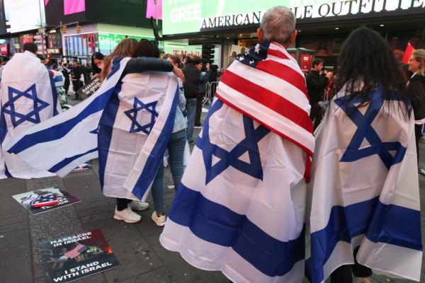 People wearing Israel flags at the Times Square rally.