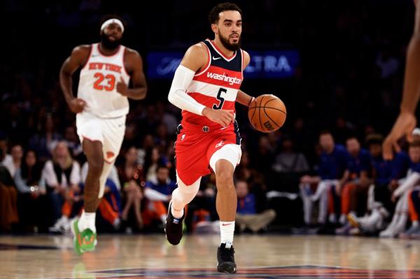 Washington Wizards guard Tyus Jo<em></em>nes (5) in action past New York Knicks center Mitchell Robinson (23) during the second half of a preseason NBA basketball game Wednesday, Oct. 18, 2023, in New York. 