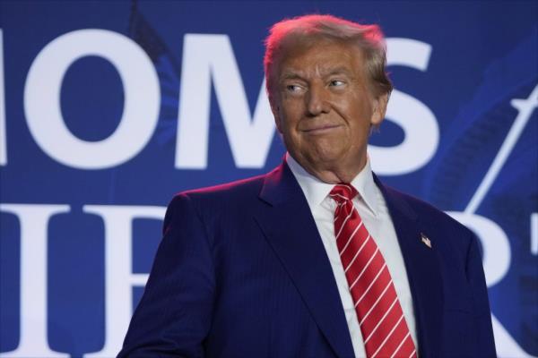 Republican presidential nominee former President Do<em></em>nald Trump arrives to speak with Moms for Liberty co-founder Tiffany Justice during an event at the group's annual co<em></em>nvention in Washington, Friday, Aug. 30, 2024.
