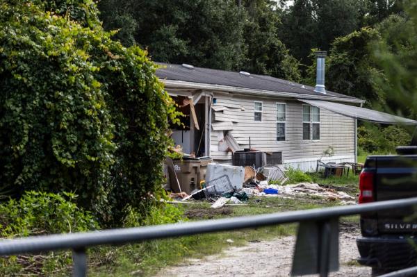 Two suspects were killed and a third was wounded when police stormed the home in an attempt to retrieve l<em></em>ink, who had been shot and was trapped inside, officials said.