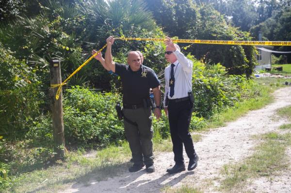 Two suspects were killed and a third was wounded when police stormed the home in an attempt to retrieve l<em></em>ink, who had been shot and was trapped inside, officials said.