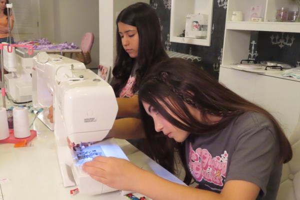 Giuliana Demma and her sister Audrina sewing pediatric hospital gowns in their home ba<em></em>sement in Freehold, N.J.