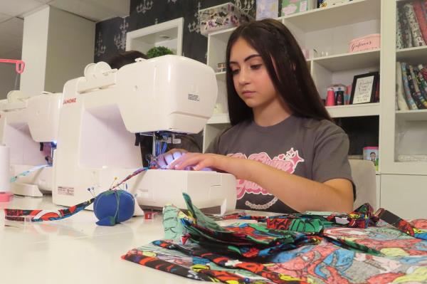 Audrina Demma sewing brightly colored pediatric hospital gowns at her home in Freehold, N.J.
