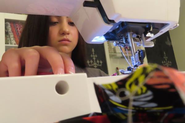 Audrina Demma sewing pediatric hospital gowns in the ba<em></em>sement of her home for children in hospitals across 36 states and Africa