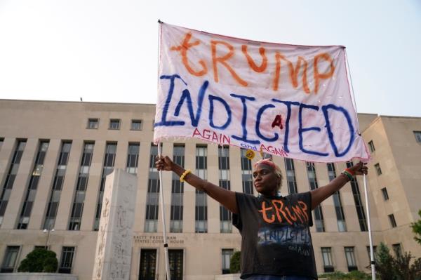 Nadine Seiler holds a sign outside the E. Barrett Prettyman United States Courthouse in Washington. Former President Do<em></em>nald Trump was indicted on four charges in the United States District Court for the District of Columbia in relation to interference in 2020 election. 